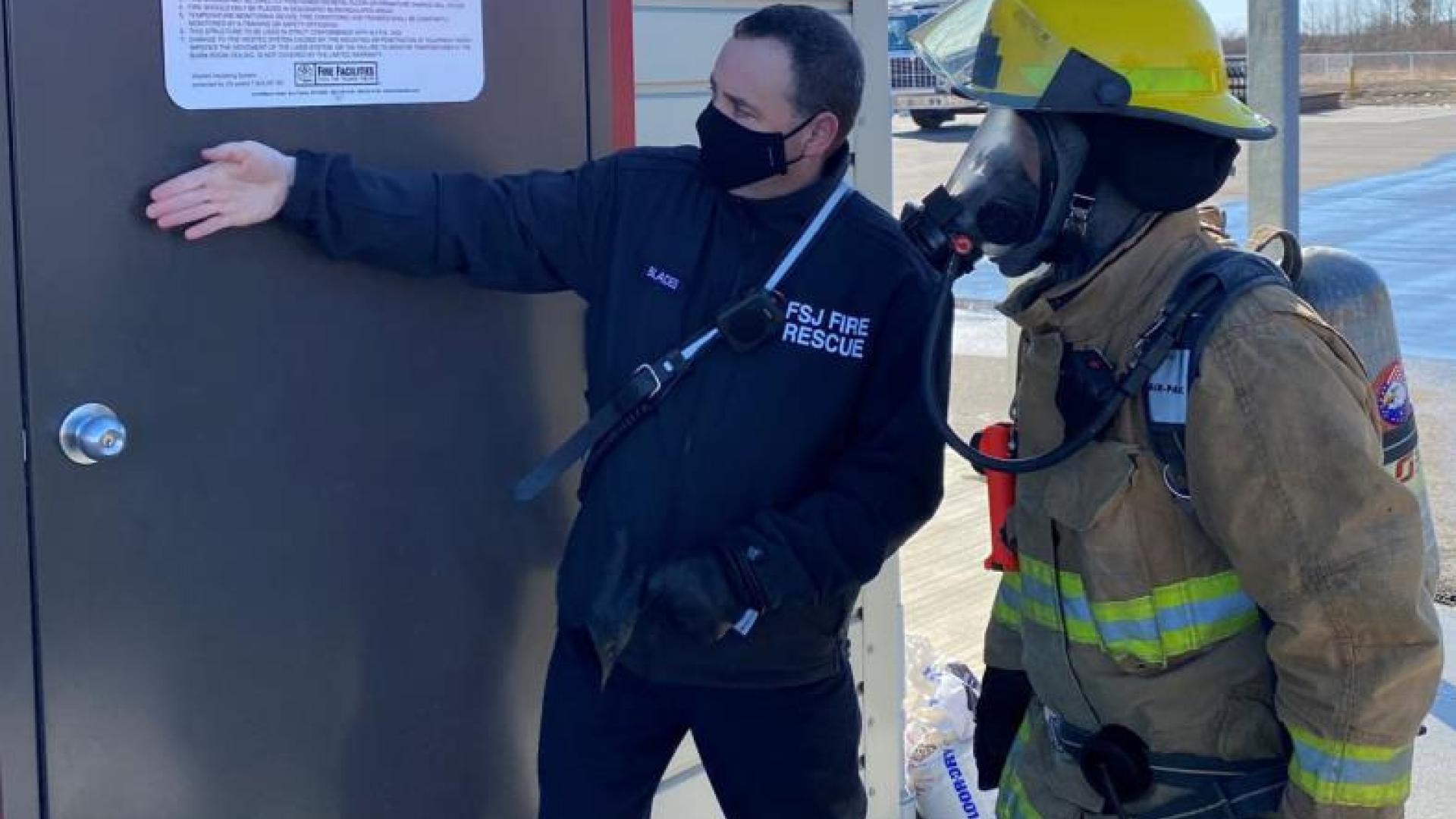 Firefighters discussing firefighting strategies.