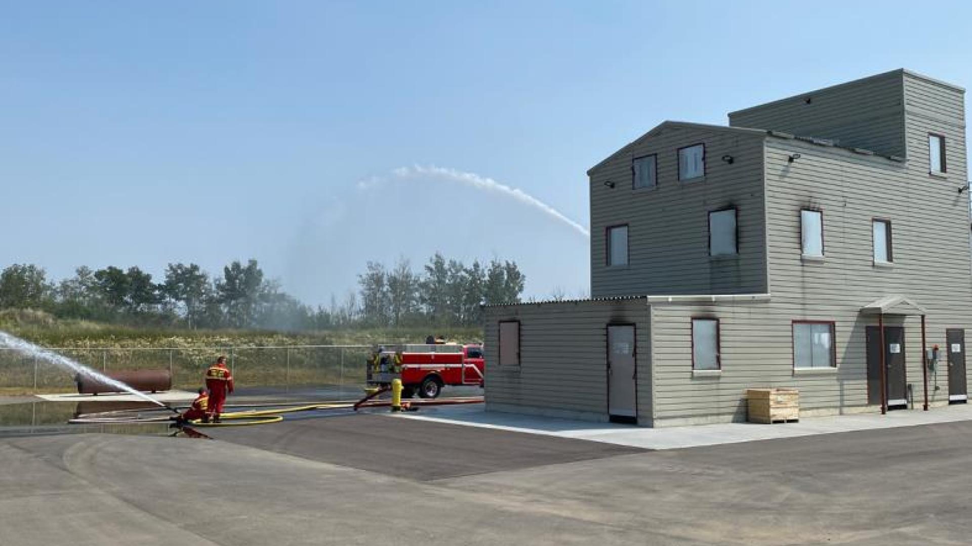 Firefighters practice fire suppression.