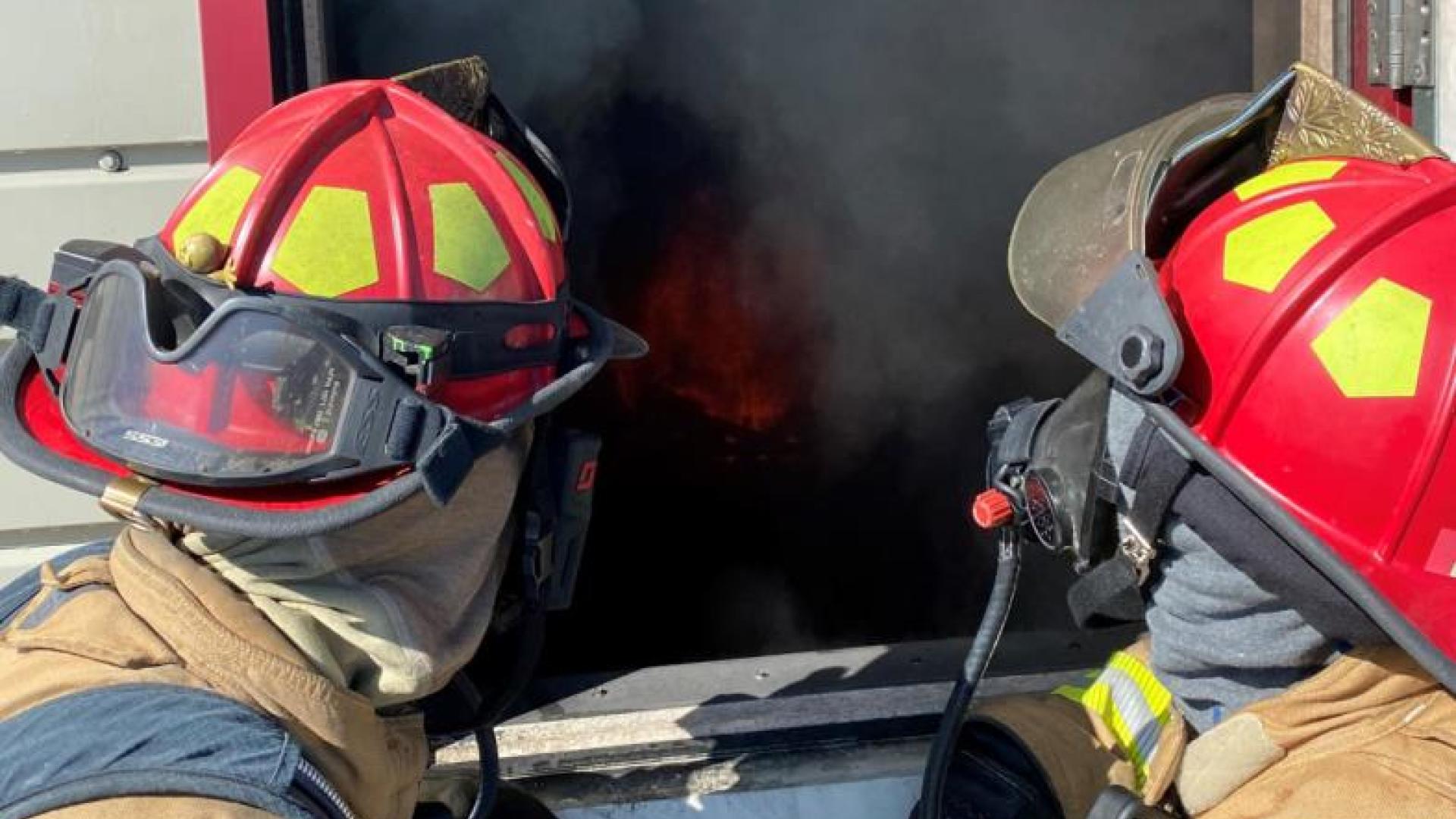 Two firefighters discuss their plan of attack.