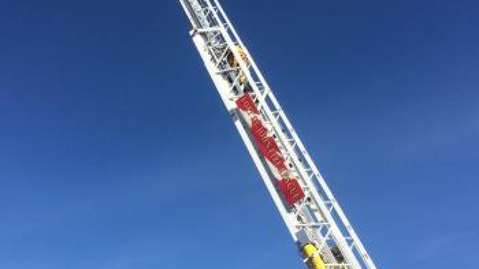 Fully extended firetruck ladder.