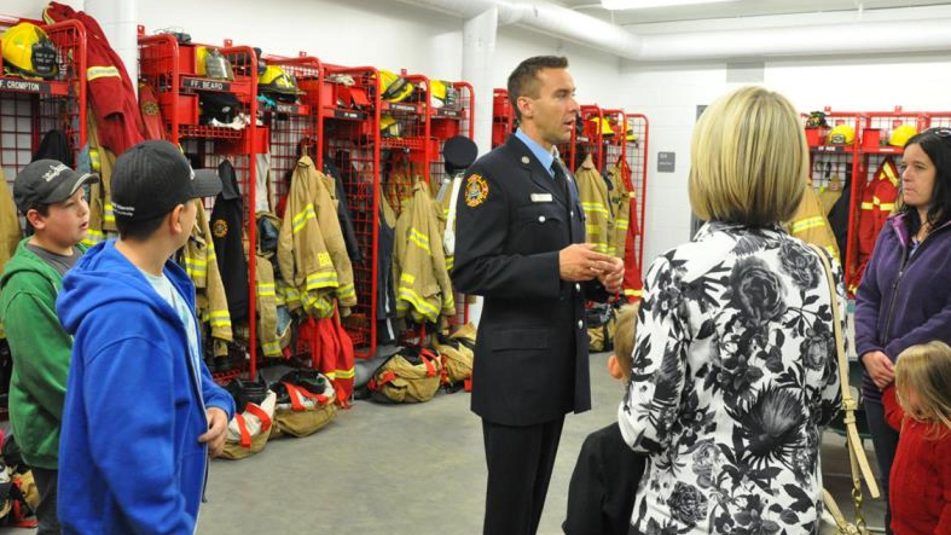 Firefighter giving visitors a tour of the fire station.