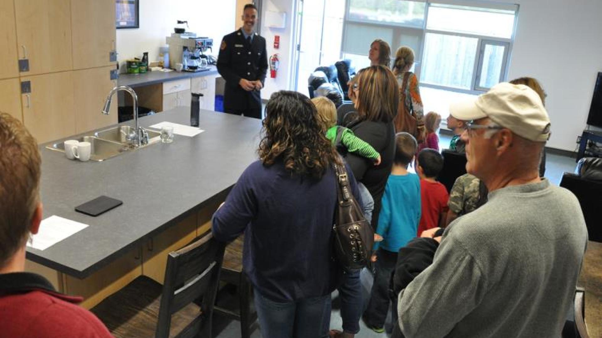 Firefighter giving visitors a tour of the fire station.