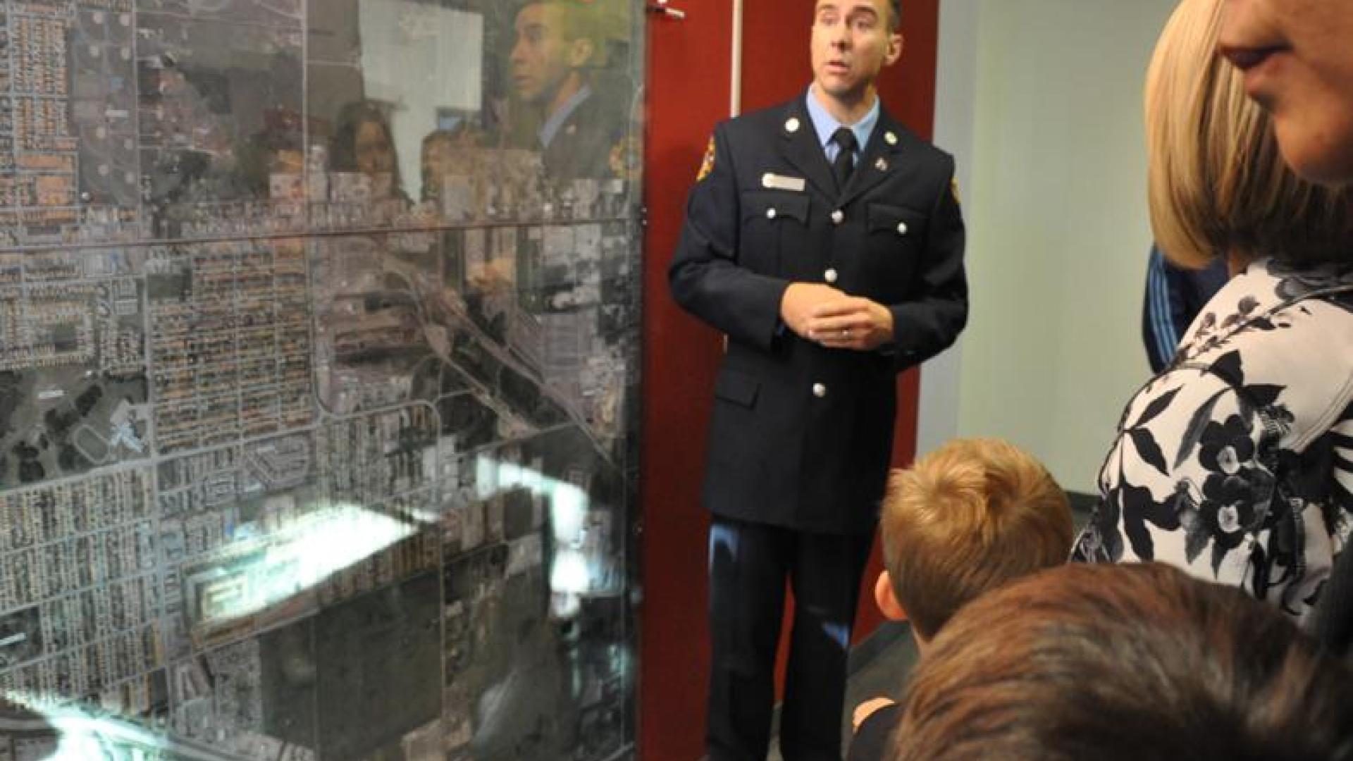 Firefighter giving visitors a tour of the fire station.