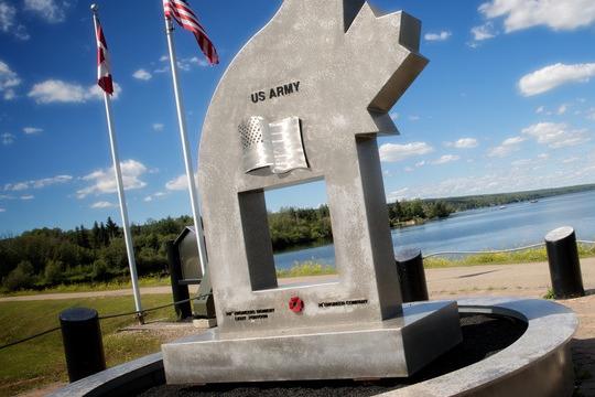 US Army monument. The American and Canadian flag are flying in the background.