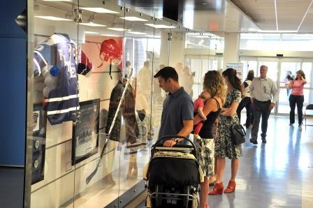 Crowd looking at sports gear display.