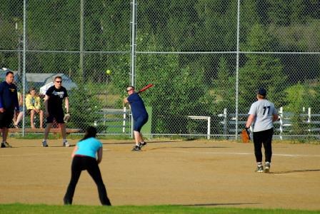 People playing softball on baseball diamond.